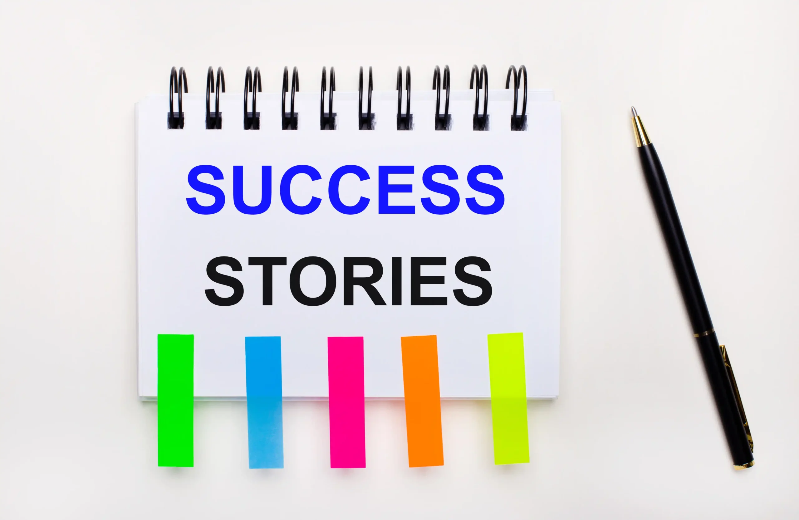 light background pen notebook with text success stories bright stickers scaled Success Stories of Brands Using Ghost Mannequin Effect Editing